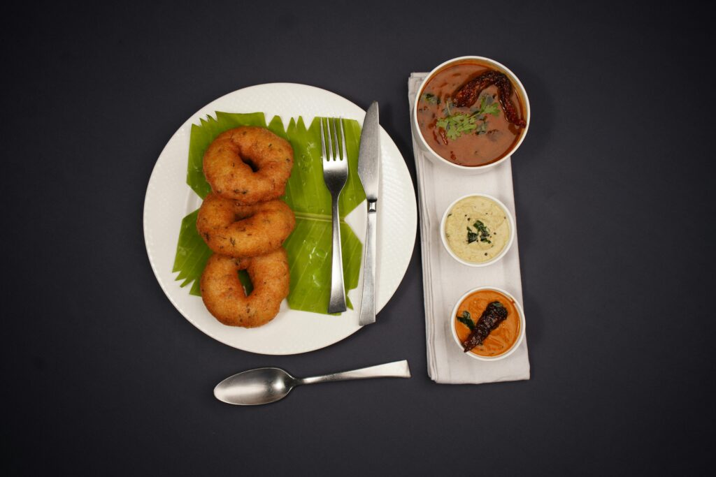Delicious South Indian breakfast featuring medu vada and chutneys.